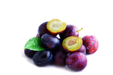 Plums. Fresh ripe washed plums over white background