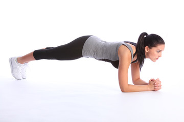 Obraz na płótnie Canvas Athletic beautiful young woman exercising on floor