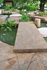 stone walkway on water in the park