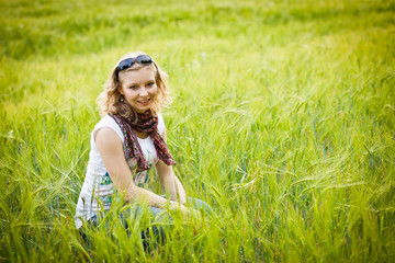 Naklejka na ściany i meble Young girl in wheat field
