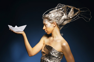 beautiful mermaid with a paper ship