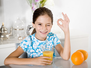 little girl drinking orange juice