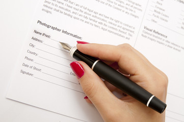 Female hand signing contract