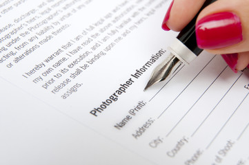 Female hand signing contract