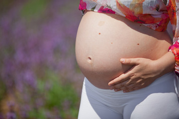 pregnant woman against plants background