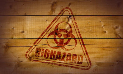 Naklejka premium Biohazard stamp on wooden background