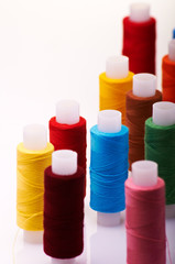 Group of multicolored spools of threads