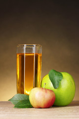 Glass of healthy fresh juice of apples on brown background