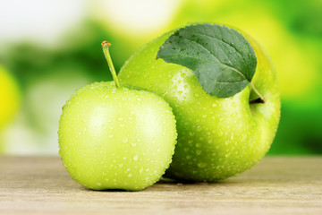 Two ripe apples on table outdoors