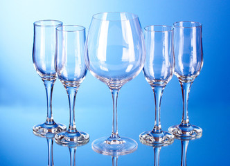 Few empty wine glasses on blue background