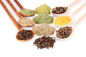 spices in the spoons isolated on white