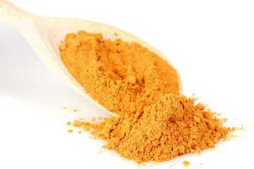 sun dried tomatoes in a wooden spoon isolated on white