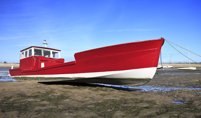 Red boat at low tide in Lege Cap Ferret, France