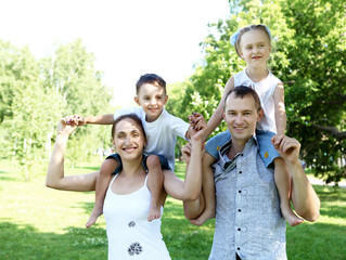 Family with two children in the summer park