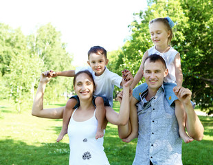 Family with two children in the summer park
