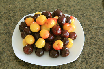 Two plates with red and yellow cherry