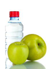 fresh green apples and plastic bottle isolated on white