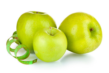 fresh green apples and measuring tape isolated on white