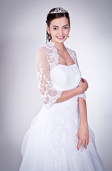 Woman in wedding dress with flowers' bouquet.