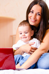 mother and son are using laptop