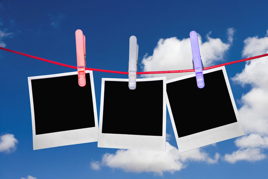 Instant photos hanging on a washing line