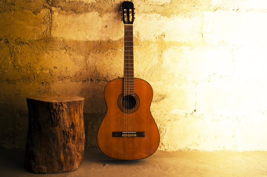 Acoustic guitar on old wall - copyspace © threecups