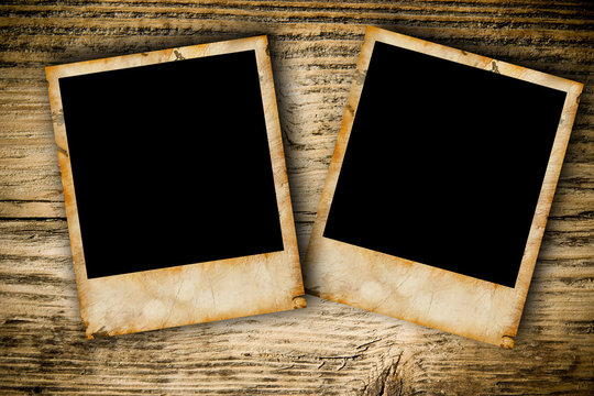 Grunge photo frames on wooden plank background