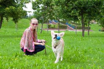 girl playing in the park with a puppy