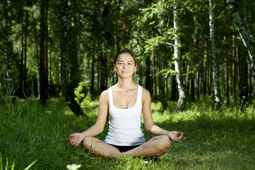 Naklejka na ściany i meble yoga woman on green grass
