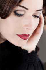 Fototapeta na wymiar Closeup of a beautiful woman with red lips looking down