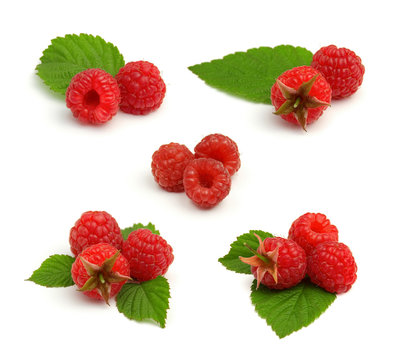 Set of red ripe raspberry heaps with leafs isolated on white