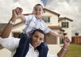 Hispanic Father and Son in Front of House