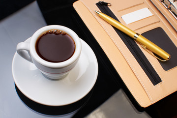 Cup of coffee with the diary