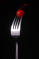Cherry Fruit on Tines of Metal Fork