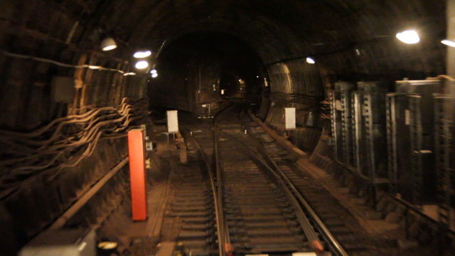 Train goes through a subway tunnel.