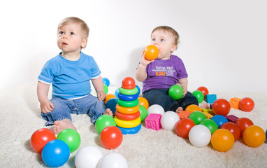 Fototapeta na wymiar Babies Play With Toys