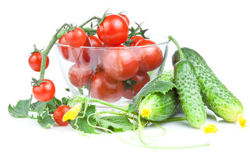 Cherry tomatoes in a salad bowl with flowers and cucumber leaves