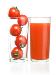Cherry tomatoes inside of a glass and tomato juice