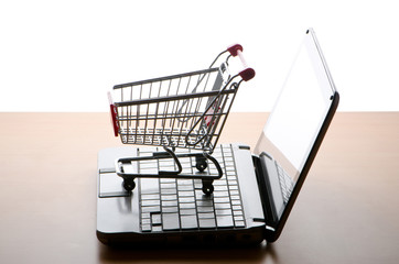 Silhoette of shopping cart and laptop