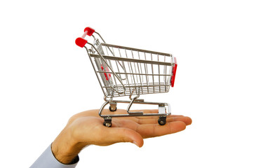 Hand holding shopping cart on white