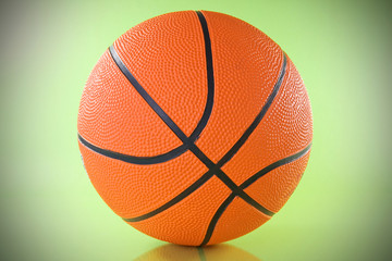 orange basketball ball over a green background.