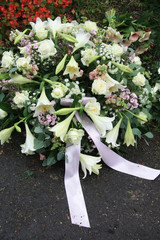 White sympathy flowers near a grave