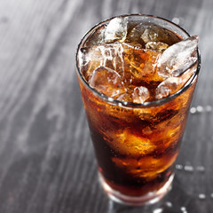 glass of cola with ice with copyspace in composition