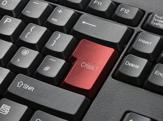 A Black Keyboard With Red Key Labelled Crisis
