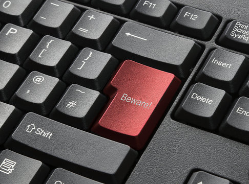 A Black Keyboard With Red Key Labelled Beware