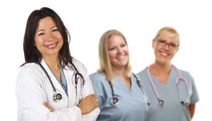 Fototapeta premium Hispanic Female Doctor and Colleagues Behind