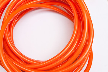 Orange garden hose coiled
