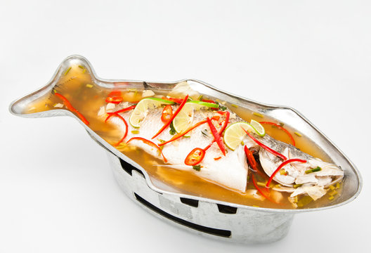 Steamed snapper fish with lemon on white background