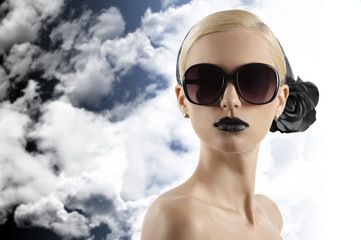 Fototapeta premium fashion shot of blond girl with sunglasses looking at the camera