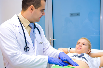Doctor examining patient's belly